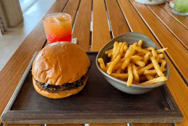 classic burger and fries plated with lemonade